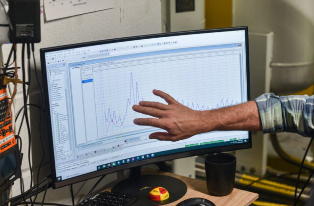 Man pointing at data on computer